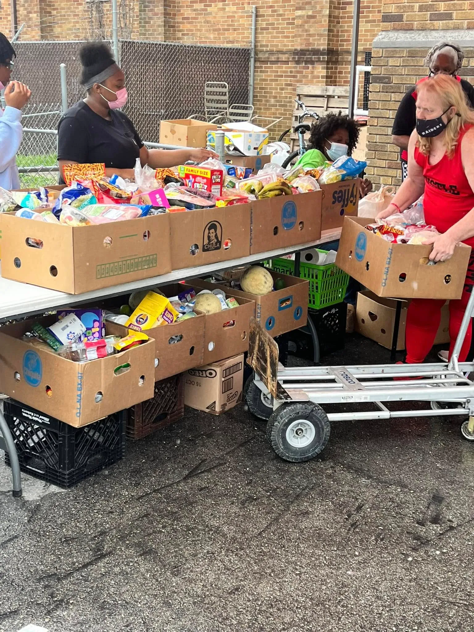Volunteers handing out boxes of groceries at the food pantry