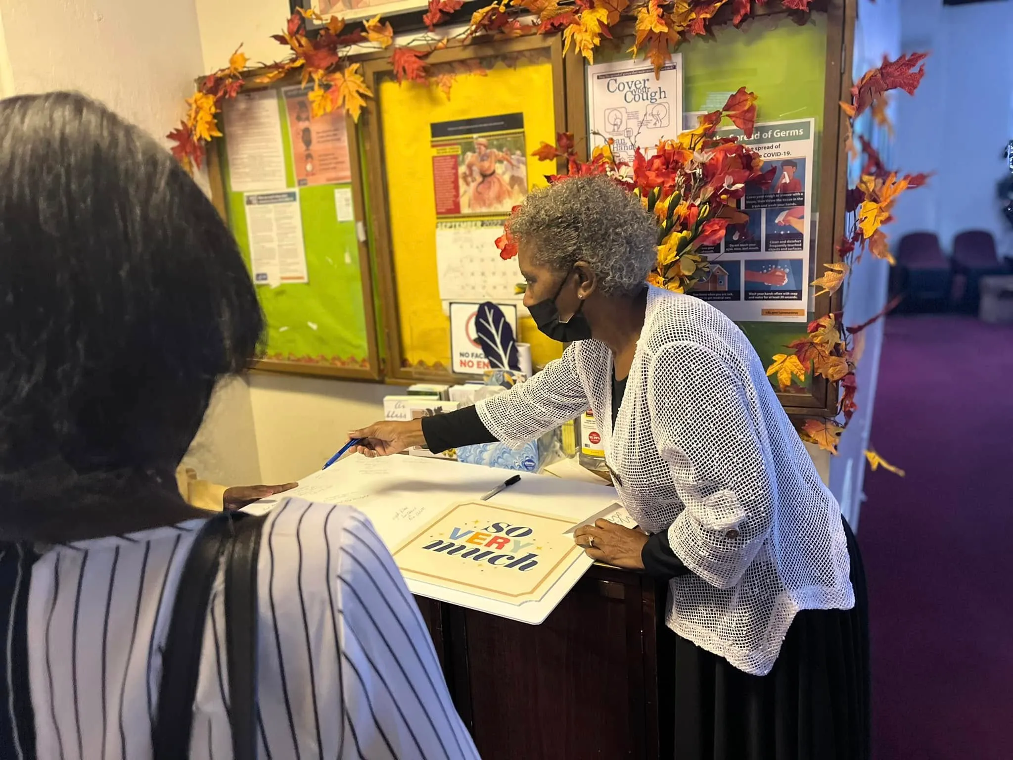 A greeter welcoming a visitor at the door
